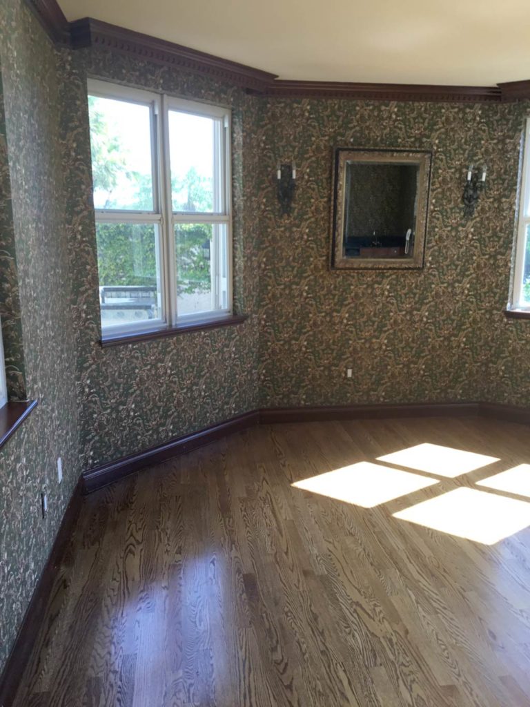 Before photo of living room with wallpaper